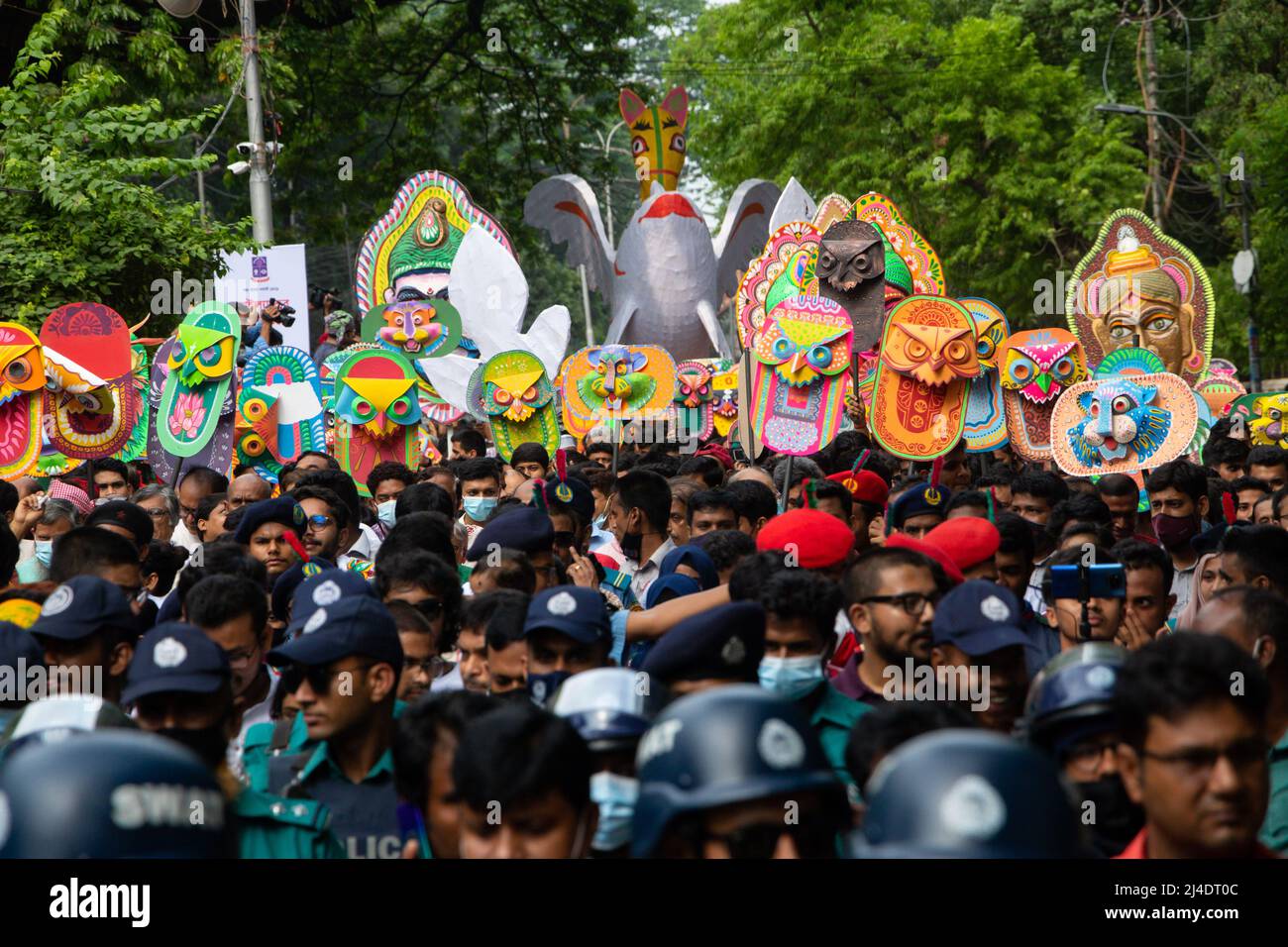 Bangladeshi people take part in a rally (Mangal Shobhajatra) in celebration of the Bengali New Year or 'Pohela Boishakh', the first day of the Bengali new year, in Dhaka, Bangladesh. Wearing colorful clothes, they carry masks and different animal floats down a street to manifest the cultural heritage of Bangladesh during the celebration. The Mangal Shobhajatra has been put on the List of Intangible Cultural Heritage of Humanity. 'Pohela Boishakh' falls every year on April 14 in Bangladesh according to the Bengali calendar or Bangla calendar. The day is celebrated across the country while the U Stock Photo
