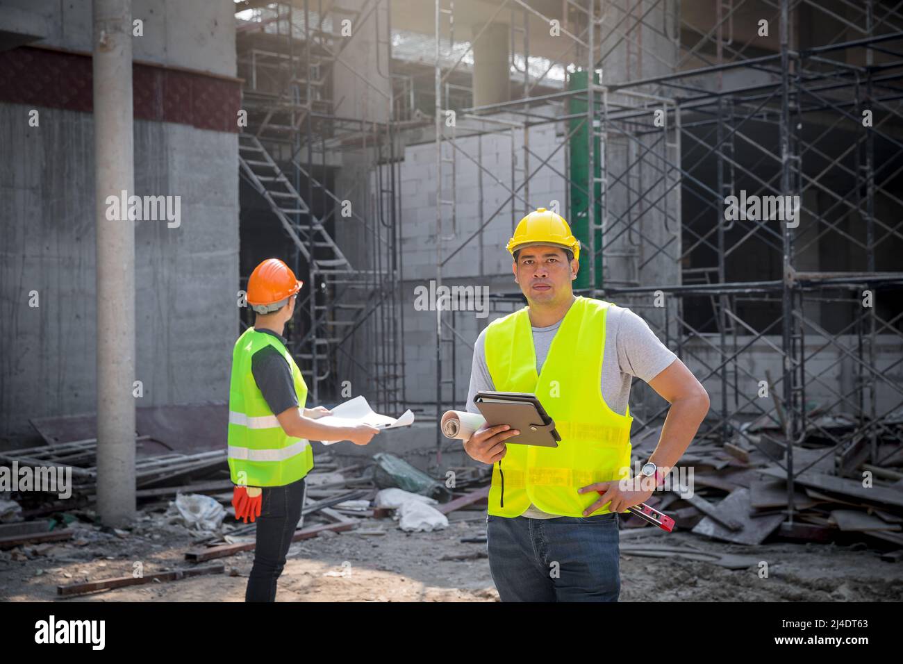 Architect, Engineer, Contractor, or Construction manager holding digital tablet standing at a construction site. Stock Photo