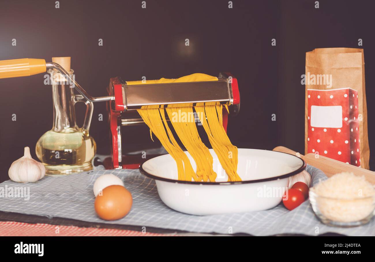 Fresh pasta cutting in machine Stock Photo Alamy