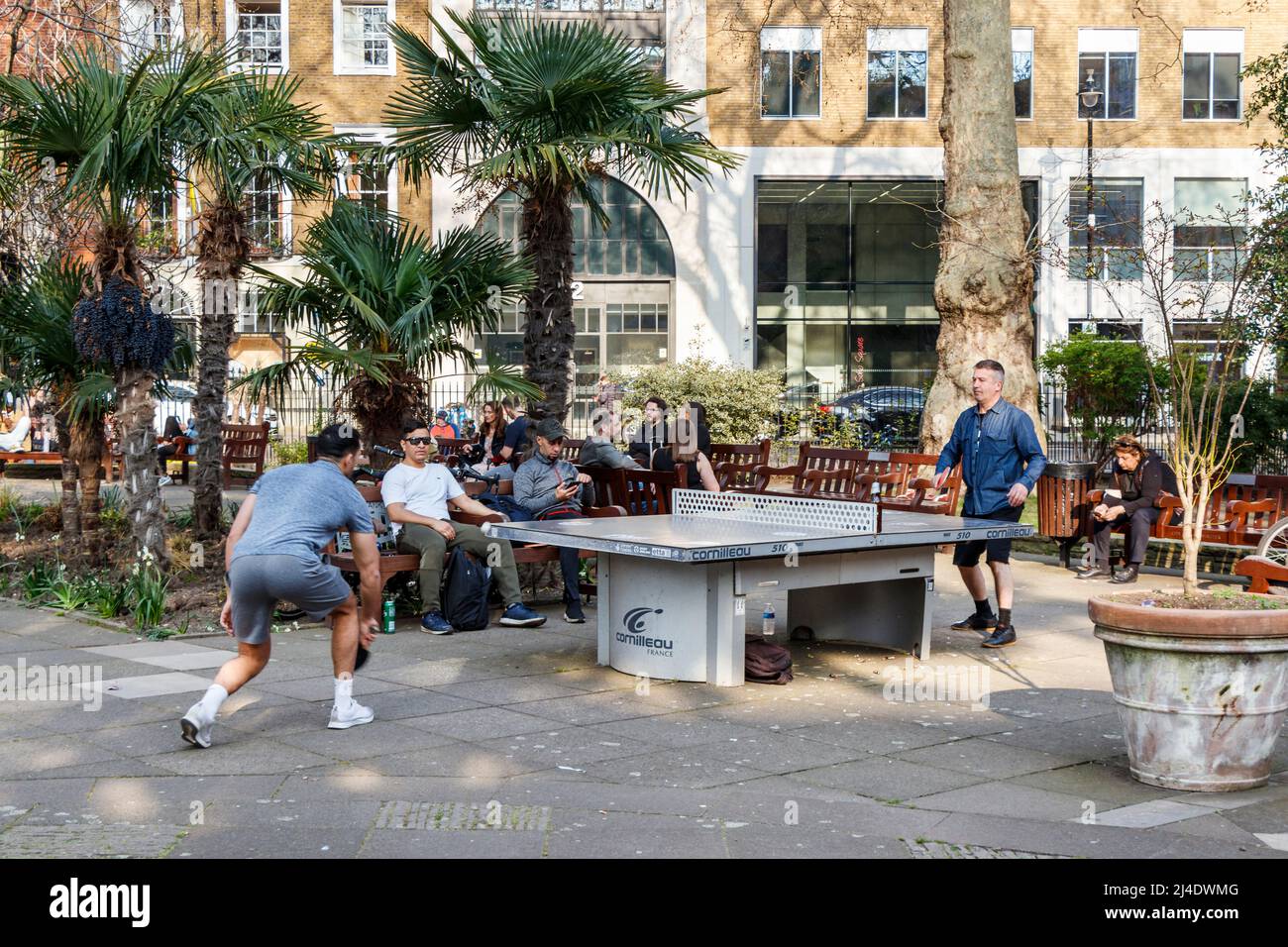 People playing table tennis in London's Soho Square as warmer weather