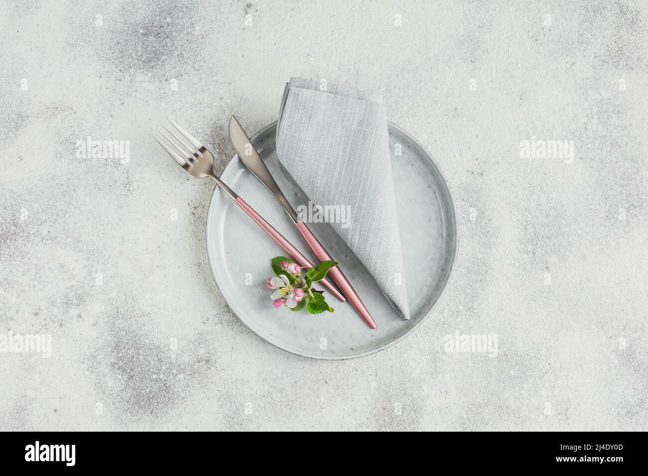 Place table setting with blossoming apple tree branches and flowers Stock Photo