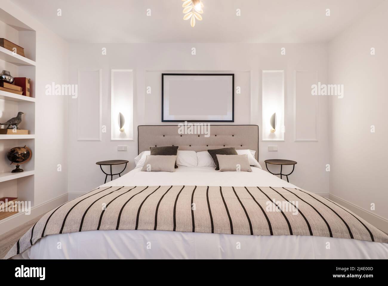 Bedroom with headboard upholstered in beige fabric, matching blanket