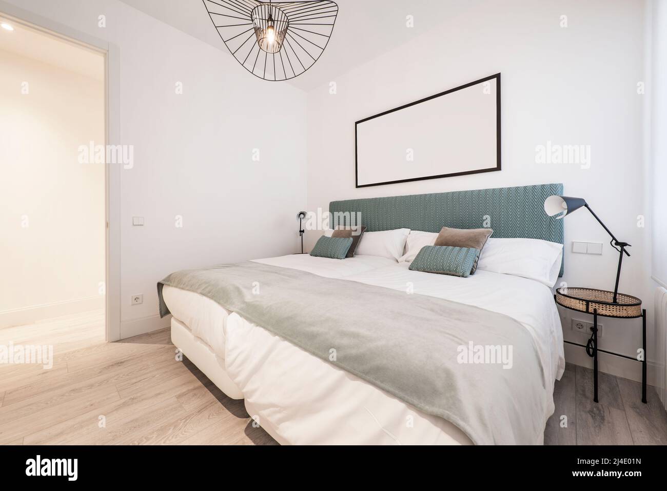 bedroom with double beds pushed together, green fabric headboard