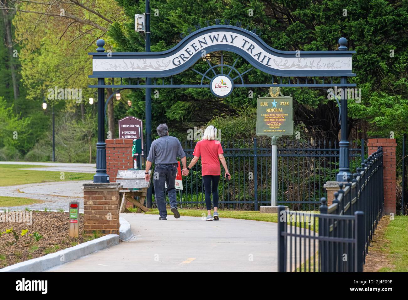 Senior couple enjoying an evening walk together on the Greenway Trail at Lilburn Park in Metro Atlanta, Georgia. (USA) Stock Photo
