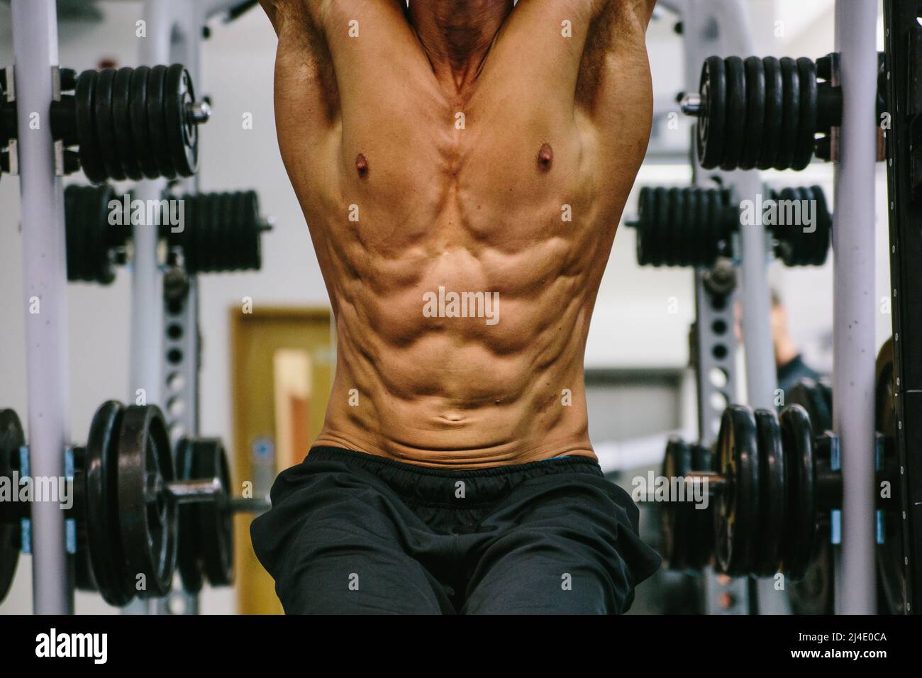 City Of London, London, UK - September 10, 2014: A man works out in a generic gym. He has a well-defined body. Stock Photo