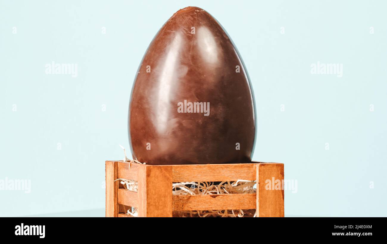 Easter chocolate egg on blue background. Easter Holiday Stock Photo