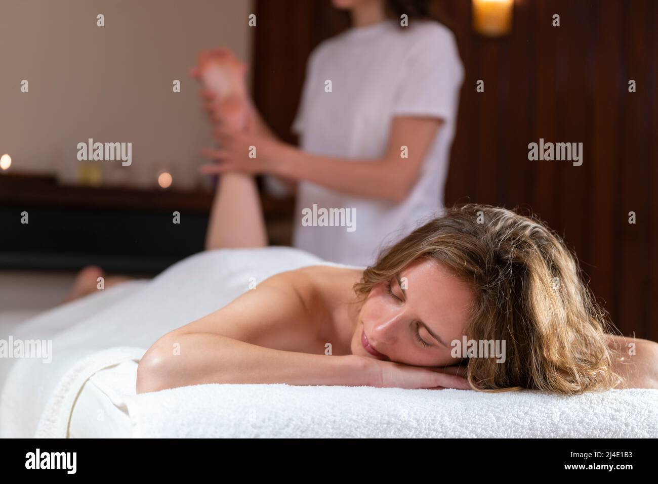 A Female physiotherapist doing a massage to another woman Stock Photo