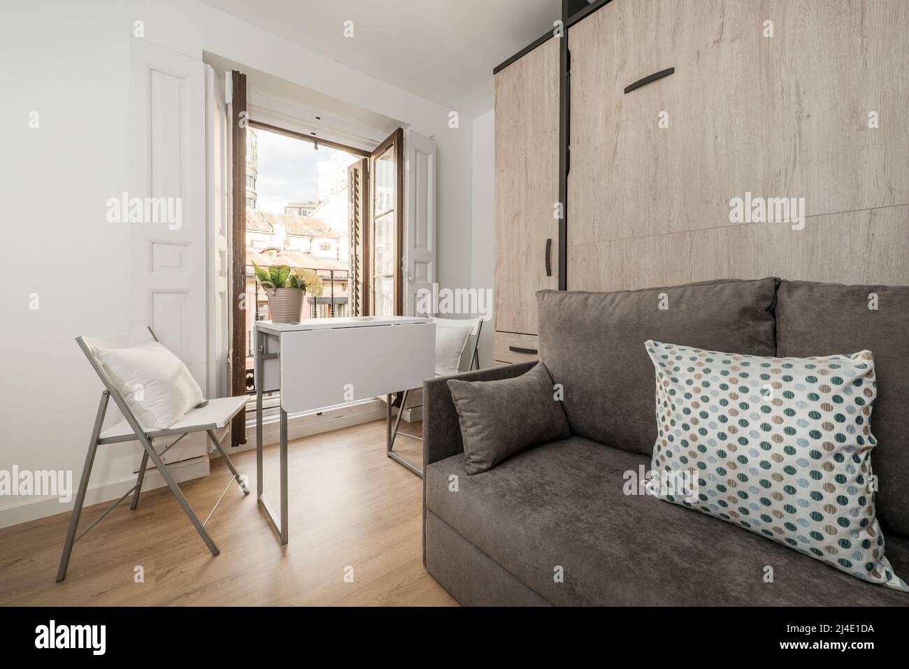 Extra bed inside sofa with cushions in shortterm rental studio