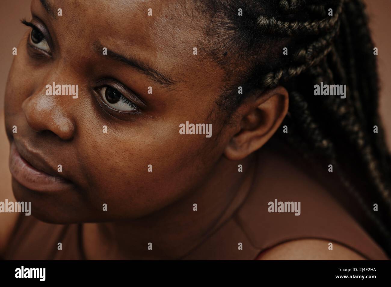 Close-up of African woman face looking up with blank expression Stock ...