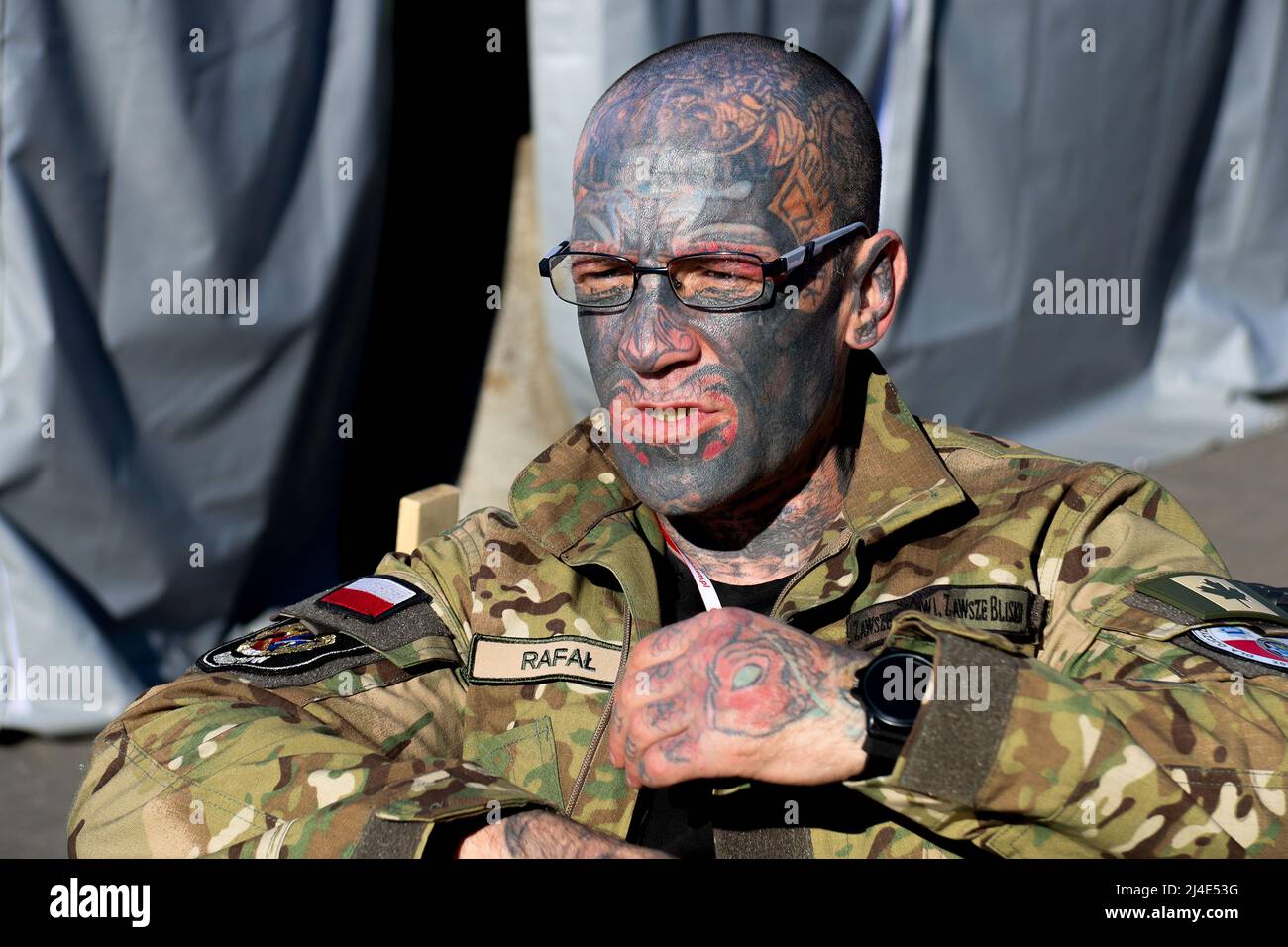 Przemysl Poland 13th Apr 22 Rafal One Of The Most Tattooed Men In The World Sits In Front Of The Pet Care Tent At Tesco Humanitarian Center Holding A Green Cross Medic