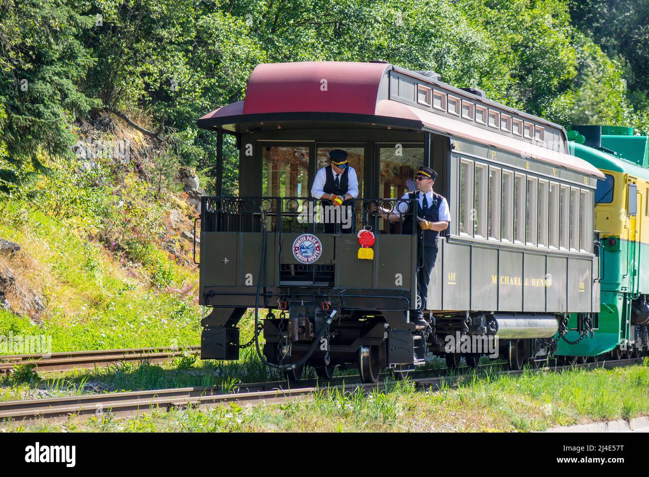 Rail Conductors Guide A Historic Rail Car Being Pushed By A Diesel Electric Train 93 White Pass Yukon Route Railway Shunted Tourist Train Passenger Tr Stock Photo