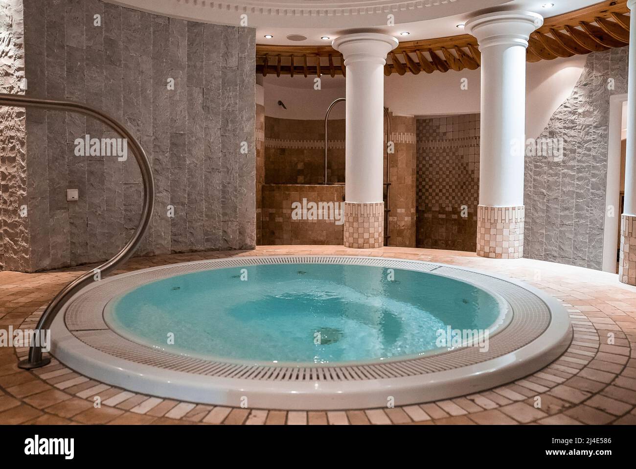 Round jacuzzi in modern bathroom with elegant style in luxurious ski resort Stock Photo