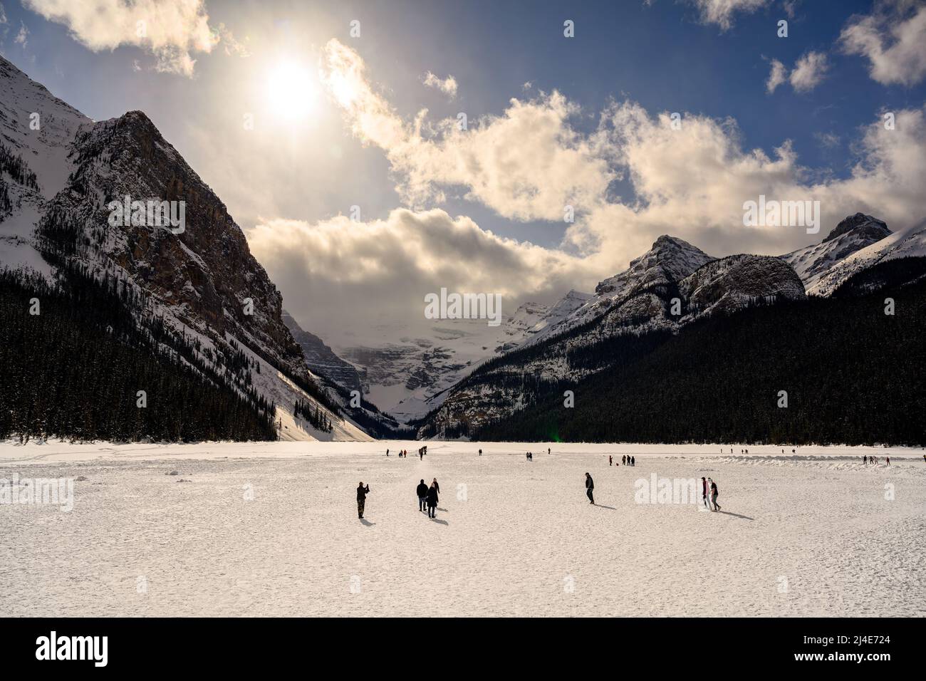 People walking on a frozen Lake Louise in Banff National Park, Alberta ...