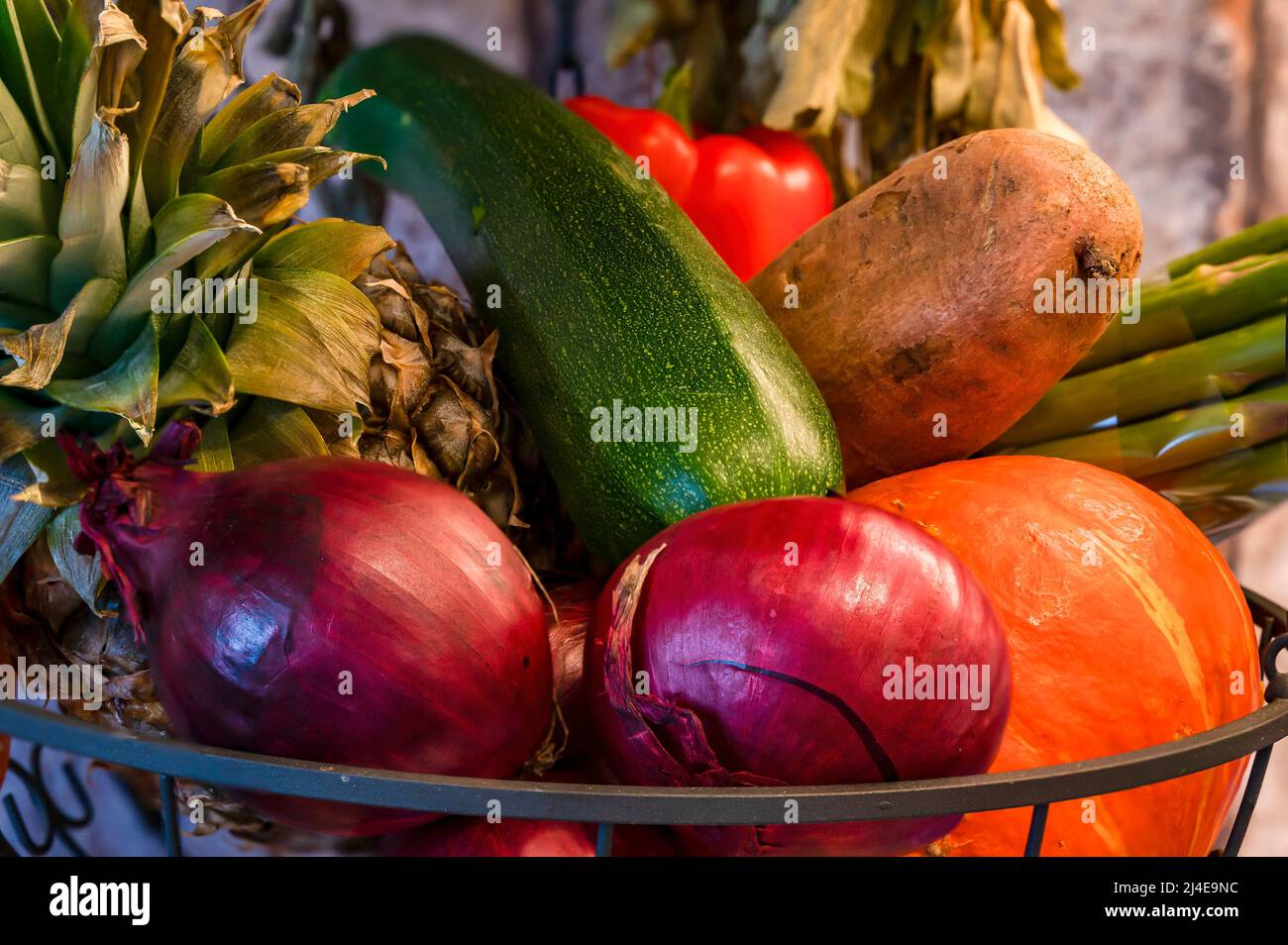Hanging basket with various fresh ingredients for cooking such as