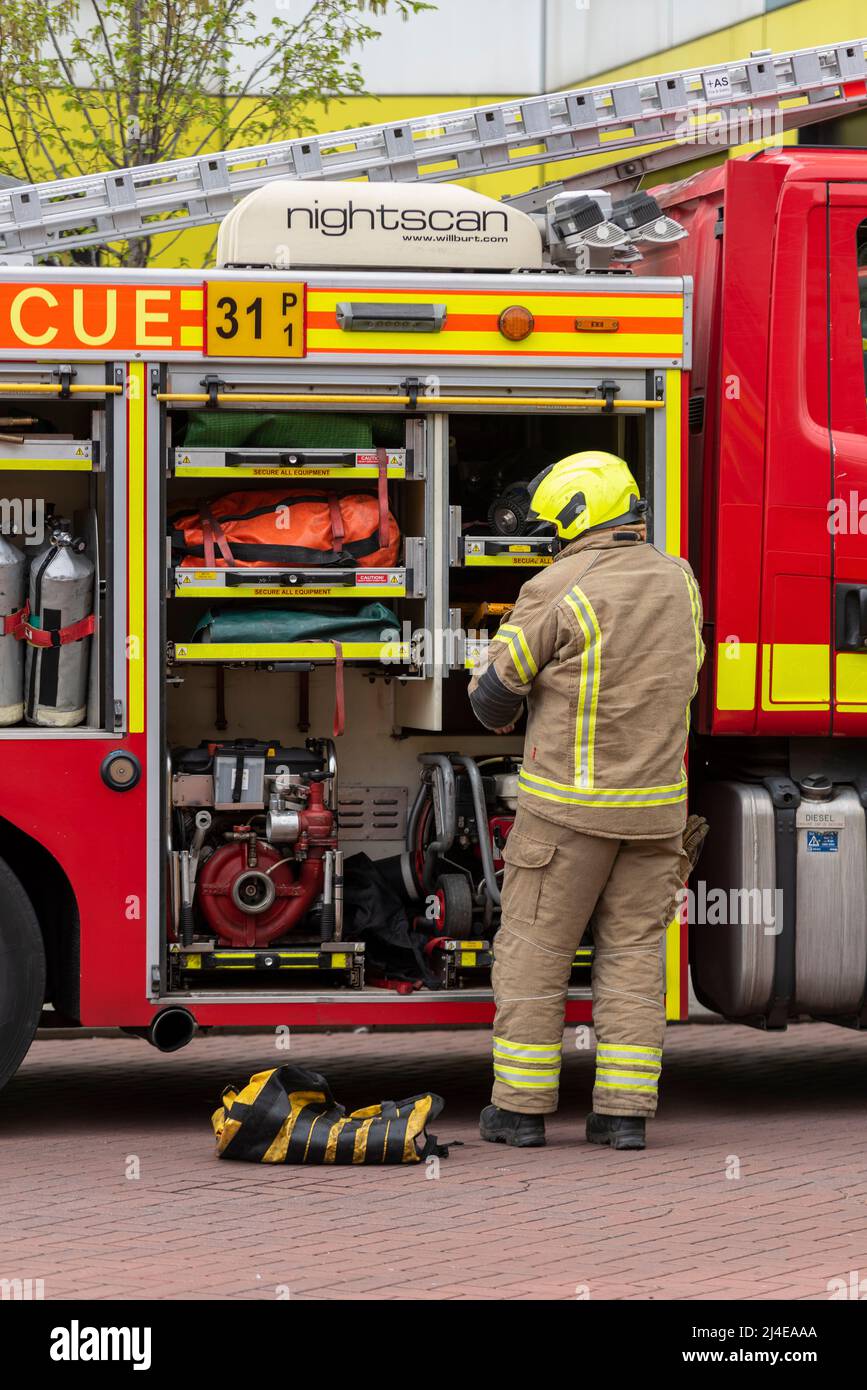 Firefighter accessing fire appliance equipment stowage lockers Essex