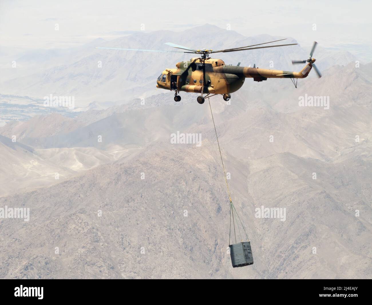 The Afghan air force and Combined Air Power Transition Force advisors conducted an operational sling load with the Mi-17 transport helicopter to Orgun-e flying 12,500 feet above sea-level and carrying a 3,200 lbs. crate, July 1. (US Air Force photo by Capt. Robert Leese/ RELEASED). The Mil Mi-17 (NATO reporting name: Hip) is a Soviet-designed Russian military helicopter family introduced in 1975 (Mi-8M), continuing in production as of 2021 at two factories, in Kazan and Ulan-Ude. It is known as the Mi-8M series in Russian service. Stock Photo