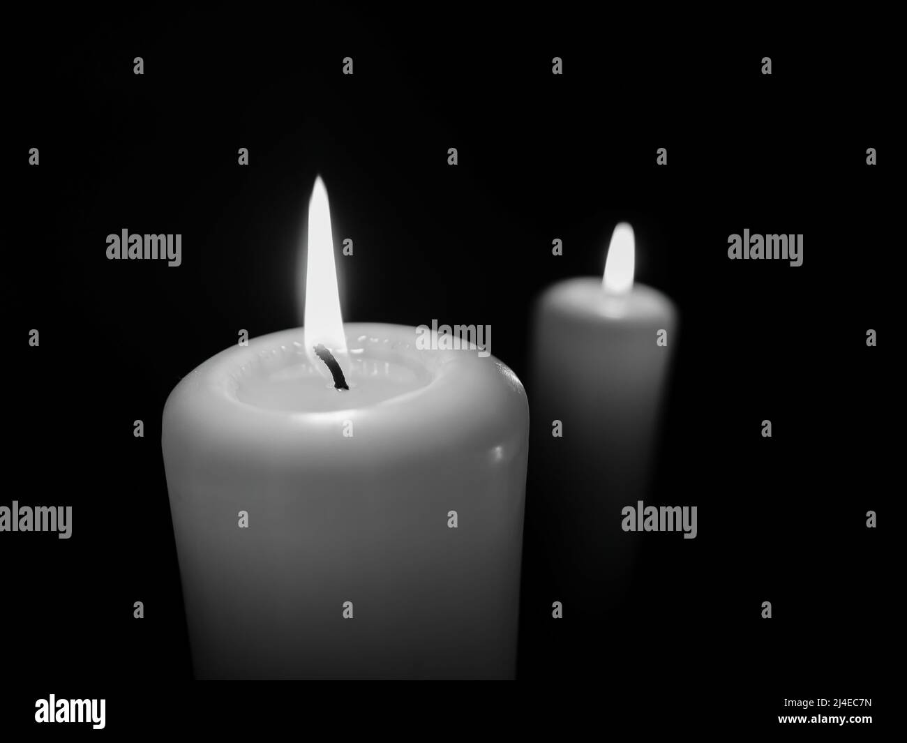 Horizontal monochrome photo of two thick lit candles Stock Photo Alamy