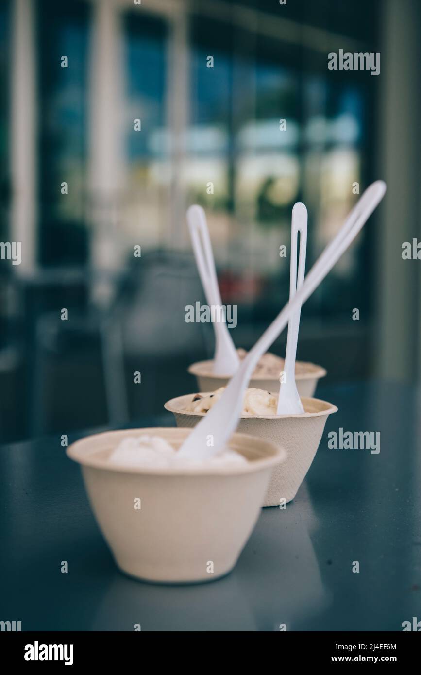 Three mini cups of vegan ice cream outside of a cafe in Michigan in summer Stock Photo