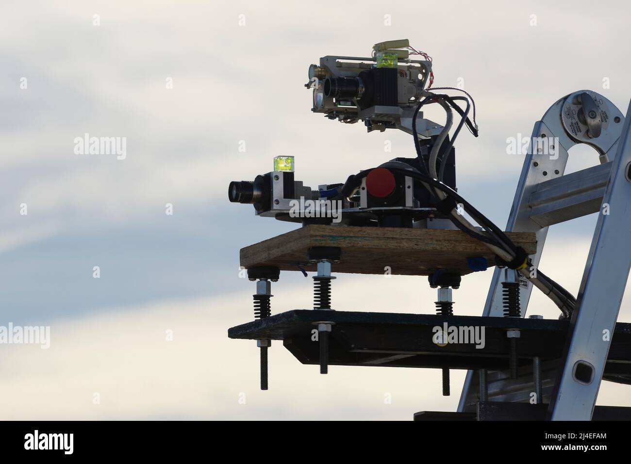 A camera and laser range finder, part of the counter-unmanned aerial system developed by the team from Wright-Patterson Air Force Base, Ohio, tracks a drone as it flies through the test airspace as part of the 2016 Air Force Research Laboratory Commanders Challenge at the Nevada National Security Site, Las Vegas, NV., Dec. 13, 2016. Teams were given six months to develop a complete counter-unmanned aerial system to aid in base defense. In addition to these devices, Wright-Patterson's system uses an attack drone with attached net for intercepting and retrieving them. (U.S. Air Force photo by We Stock Photo