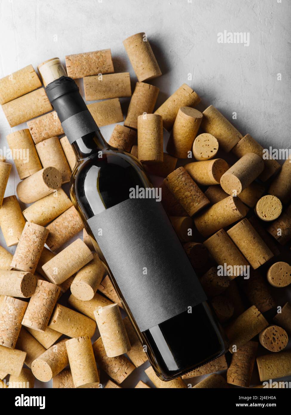 On the wine corks is a bottle of red collection wine. Solar lighting. Wine tasting invitation, advertising business, banner. Holiday, banquet, restaur Stock Photo