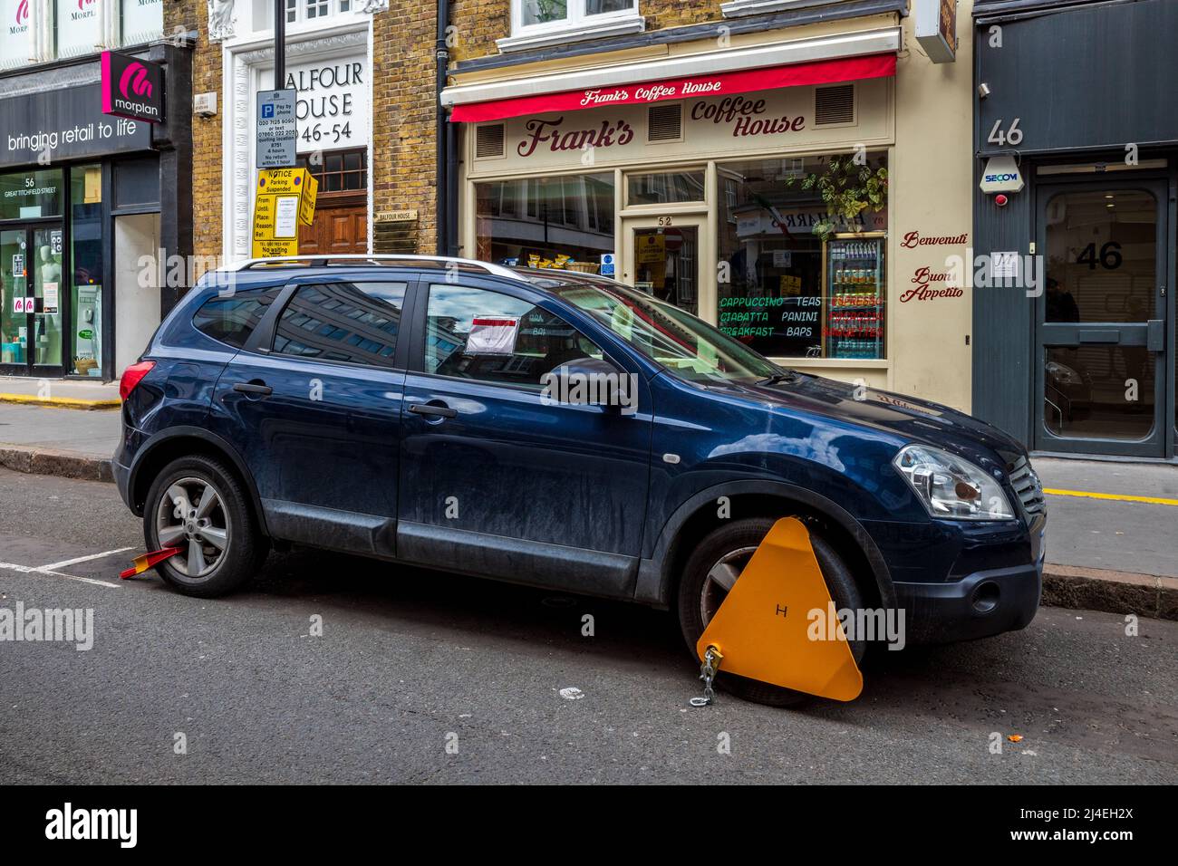 Clamped car in Soho Central London - car clamped due to parking violation in central London. Stock Photo