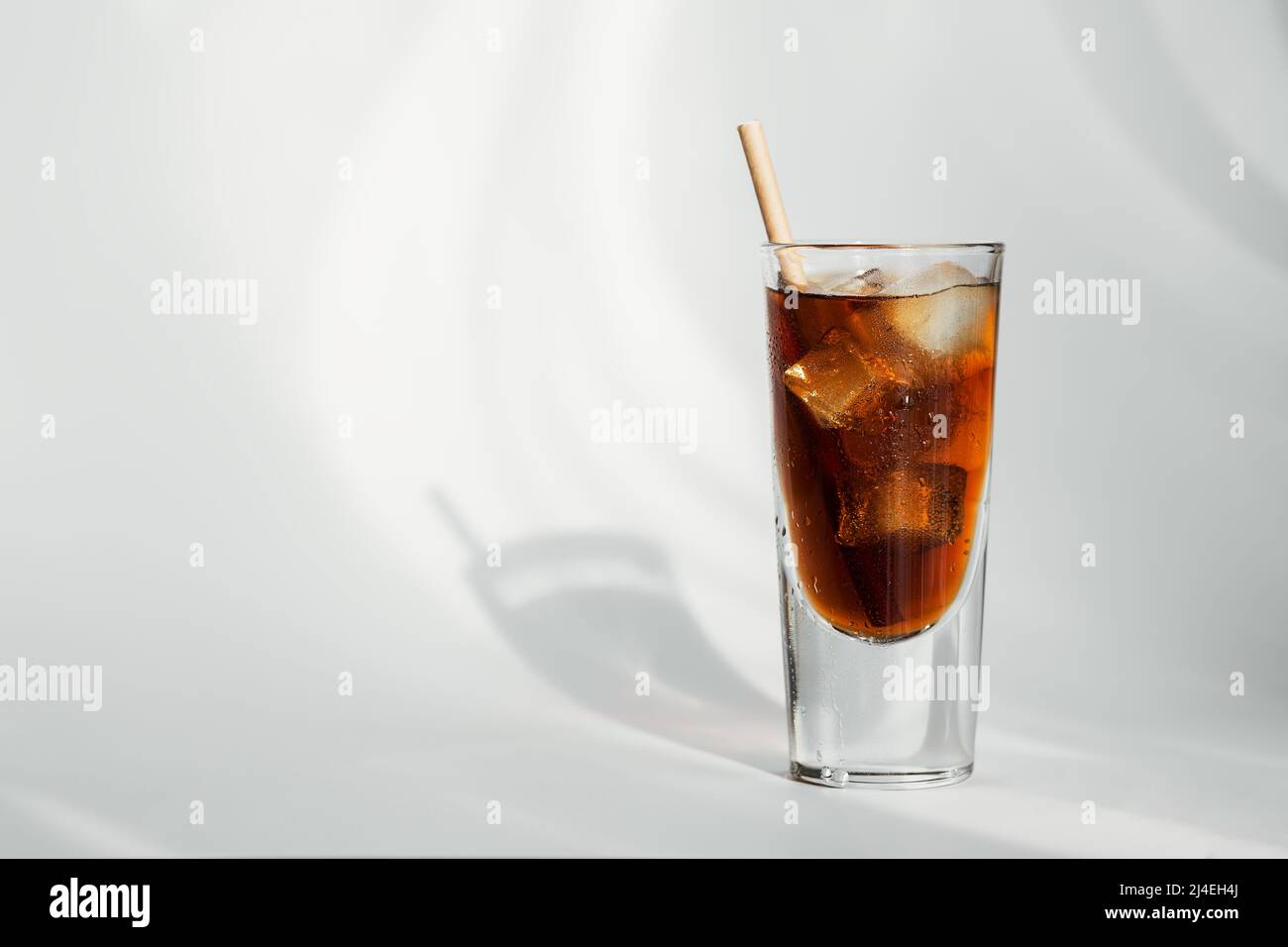 Glass of cola with ice and straw on a white background Stock Photo - Alamy