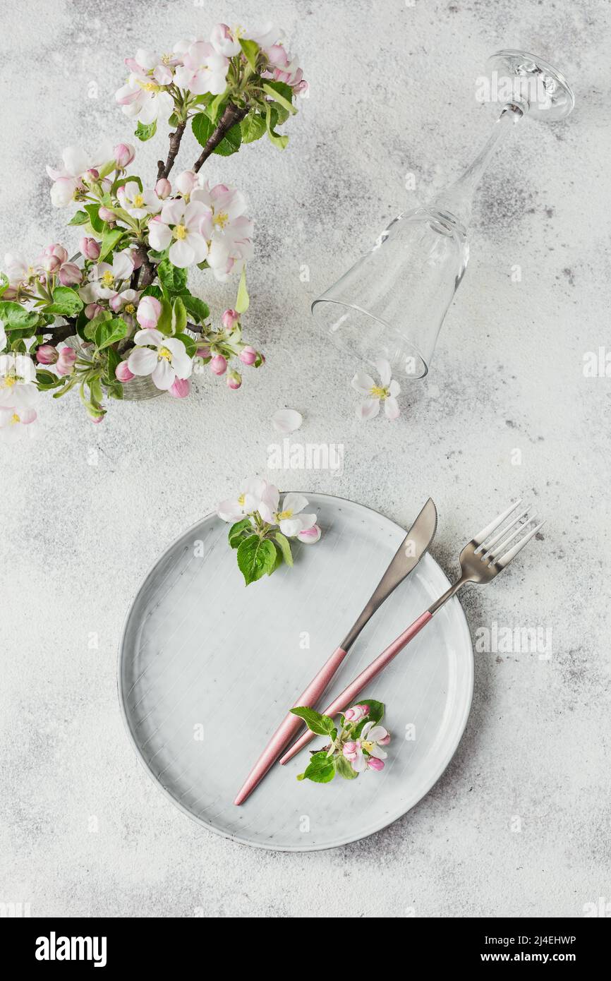 Plase table setting with blossoming apple tree branches and flowers Stock Photo