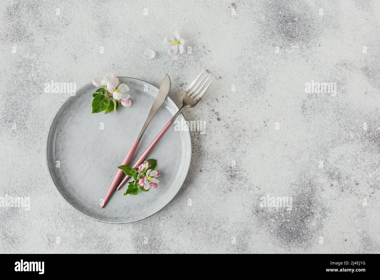 Plase table setting with blossoming apple tree branches and flowers Stock Photo