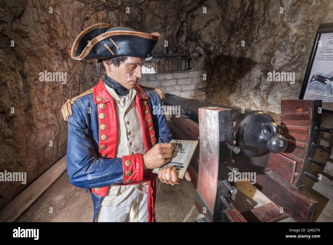 Lieutenant in 1760s uniform calculating use of Koehler's gun carriage at a cannon emplacement, Great Siege Tunnels, Gibraltar Stock Photo