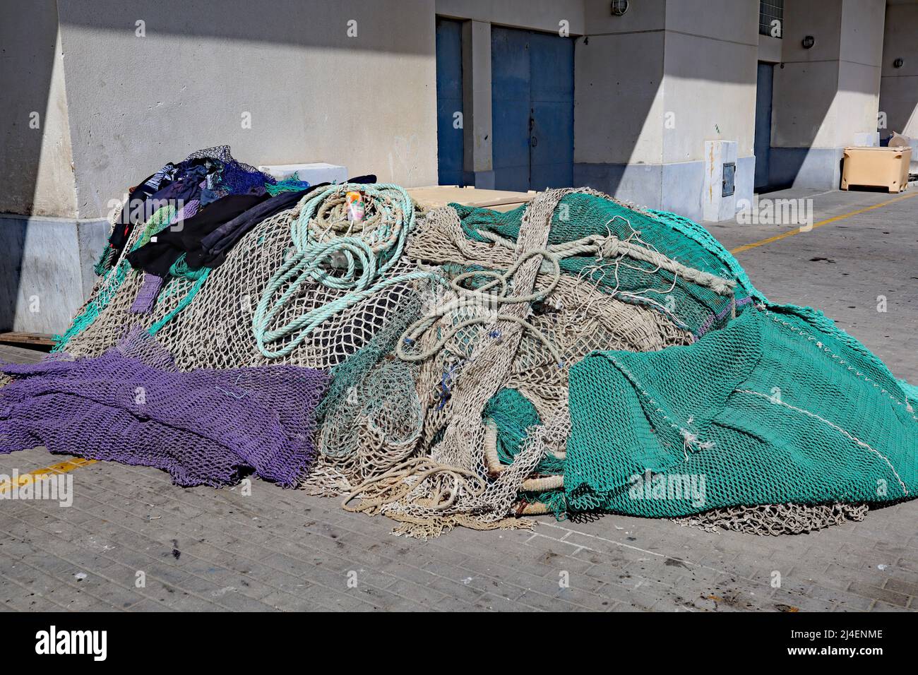 An untidy pile of fishing nets at the edge of the beach in Estepona in