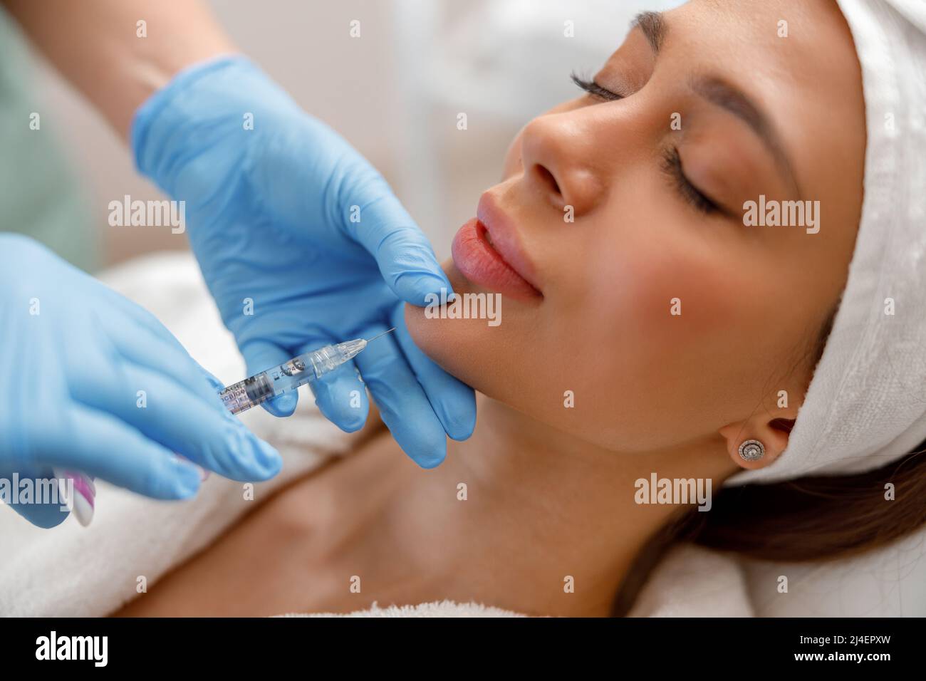 Closeup of young woman receiving hyaluronic acid injection in beauty salon Stock Photo