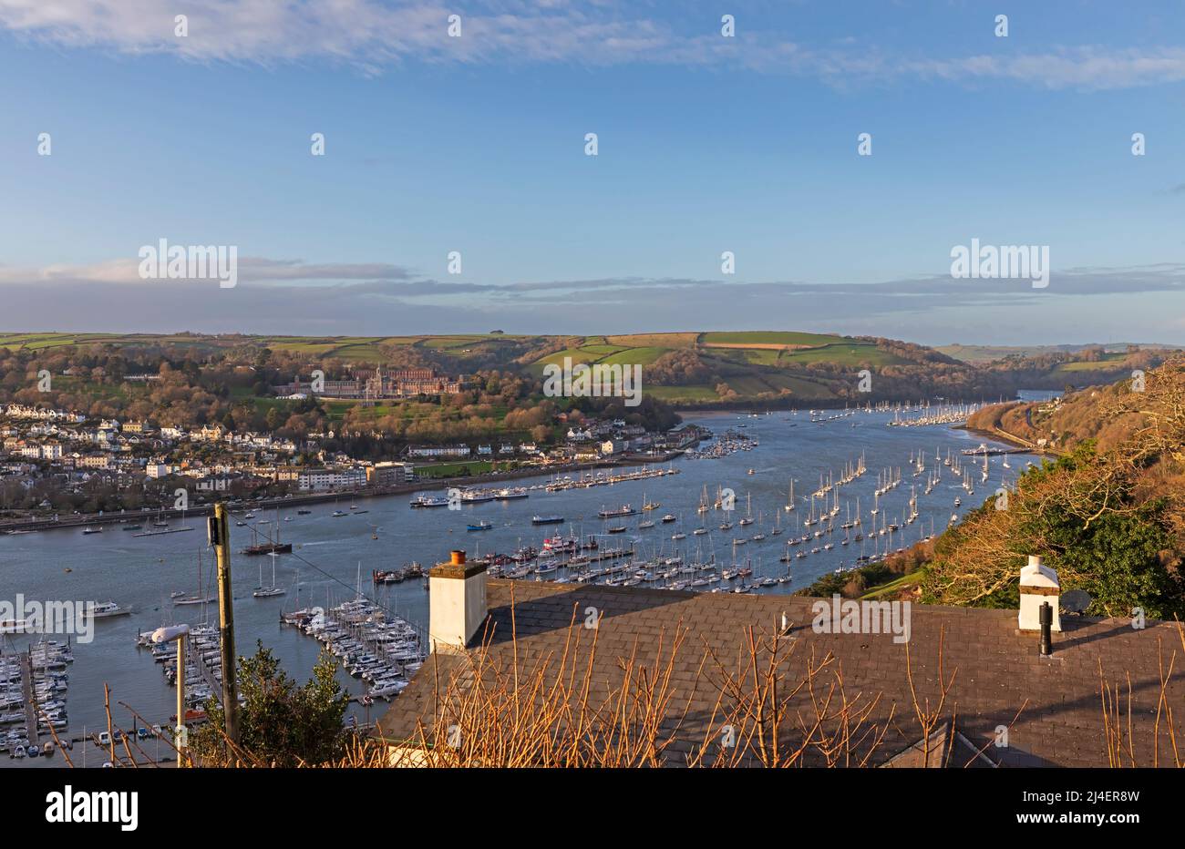 Dartmouth and the River Dart from Kingswear, South Hams, Devon. Sailboats are docked in the marina and moored in the tidal river. Stock Photo
