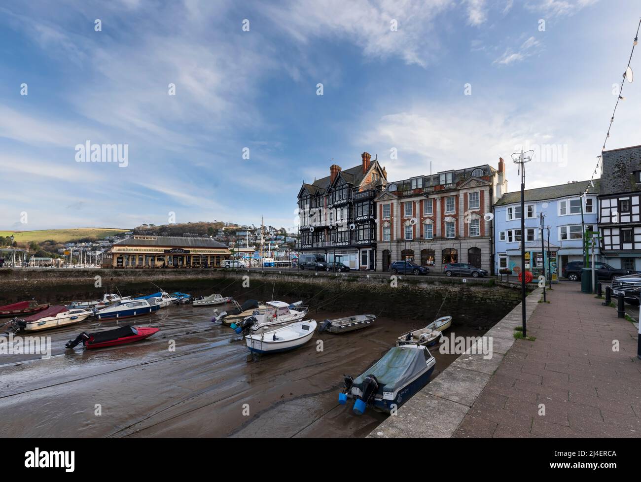 Dartmouth Inner Harbour at low tide, South Hams, Devon. boats sit in the mud of the basin until the water returns with the incoming tide. Historic bui Stock Photo