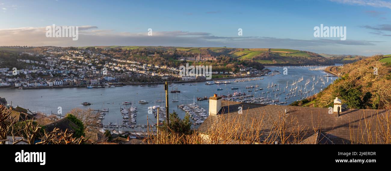 Panoramic image of Dartmouth and the River Dart from Kingswear, South Hams, Devon. Sailboats are docked in the marina and moored in the tidal river Stock Photo