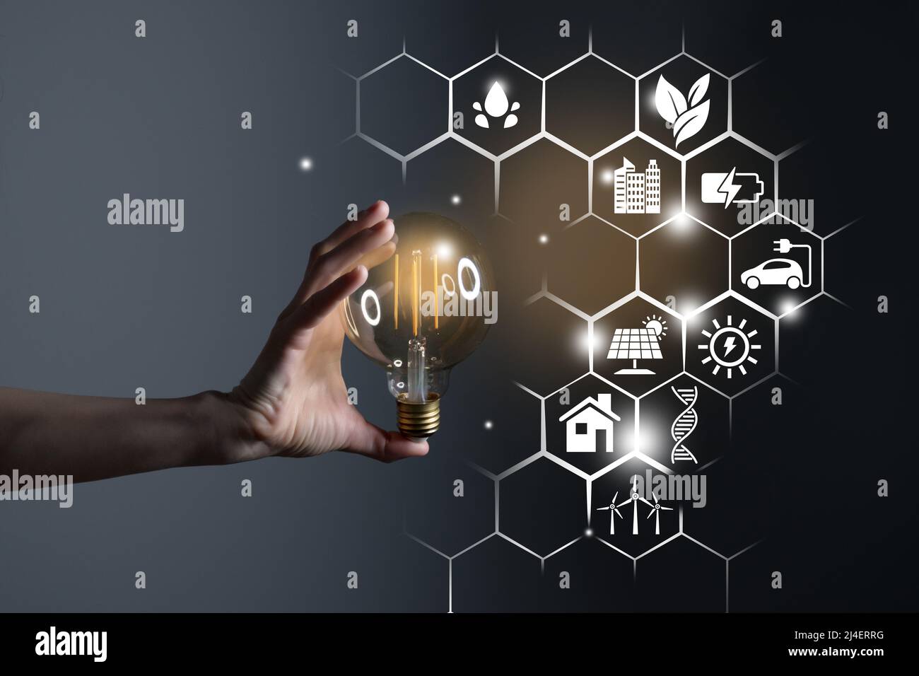Woman hand holding light bulb with icons energy sources for renewable ...