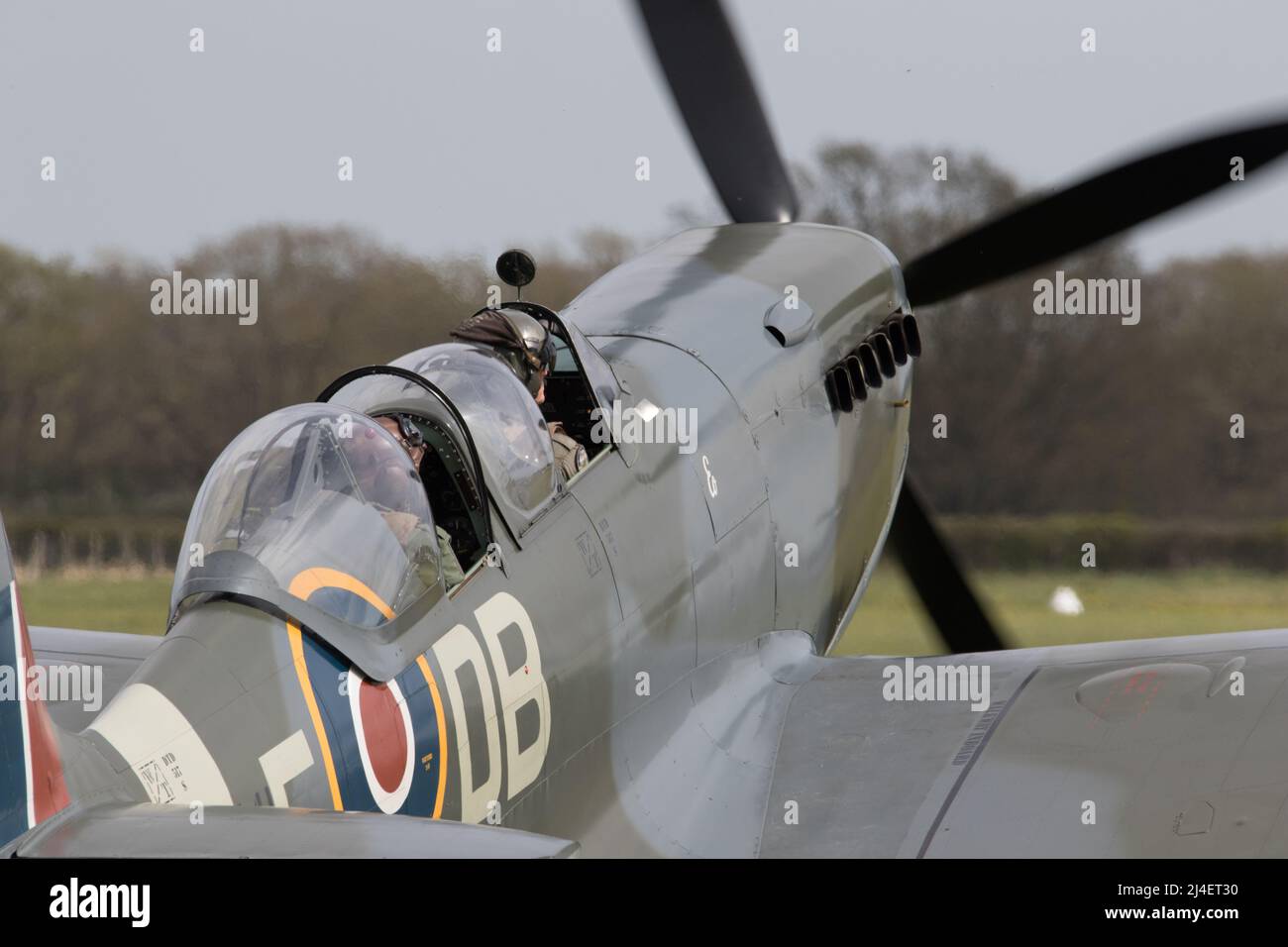 Spitfire taking off and landing at Kent airfield Stock Photo