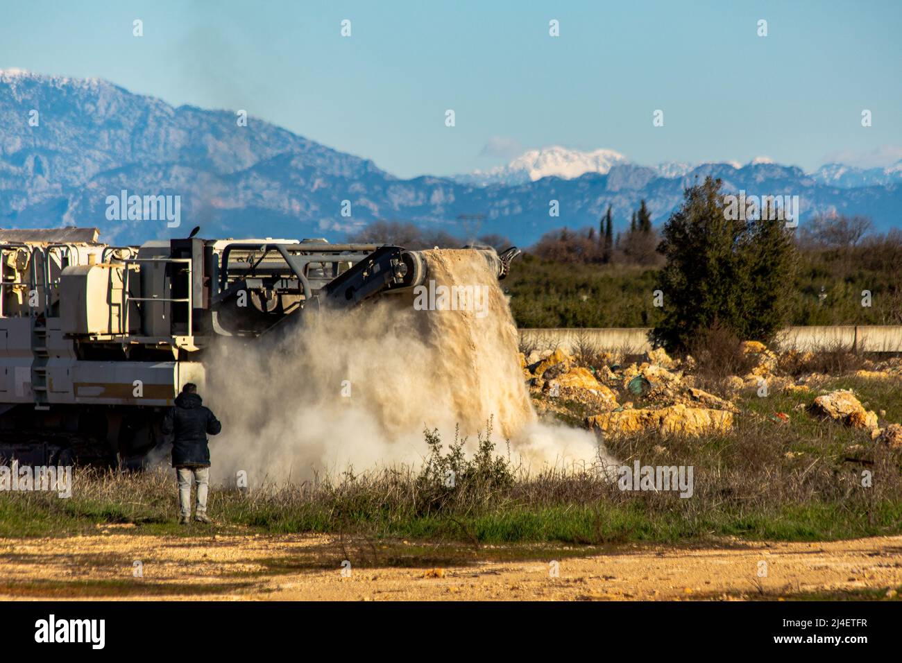 Stone filled crusher with stone crusher and bucket Stock Photo