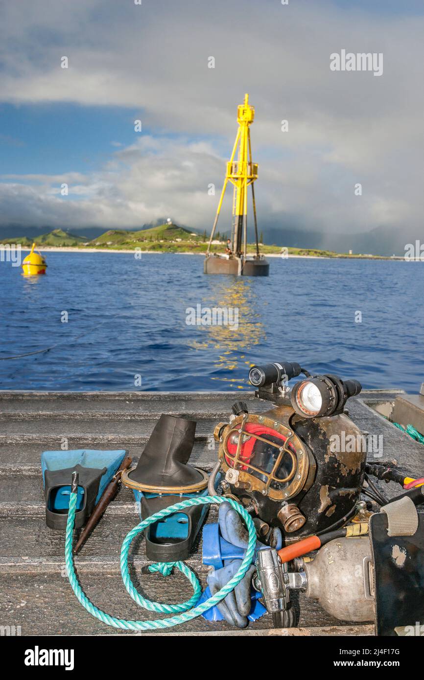 Commercial dive helmet and gear on the stern of a barge installing a