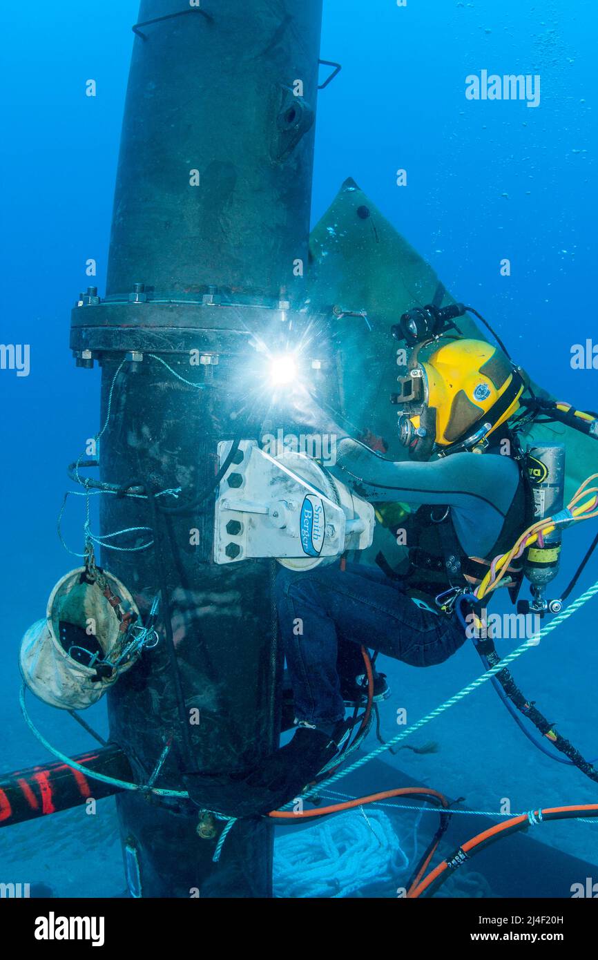 A commercial hard hat diver (MR) welding a massive wave energy buoy off