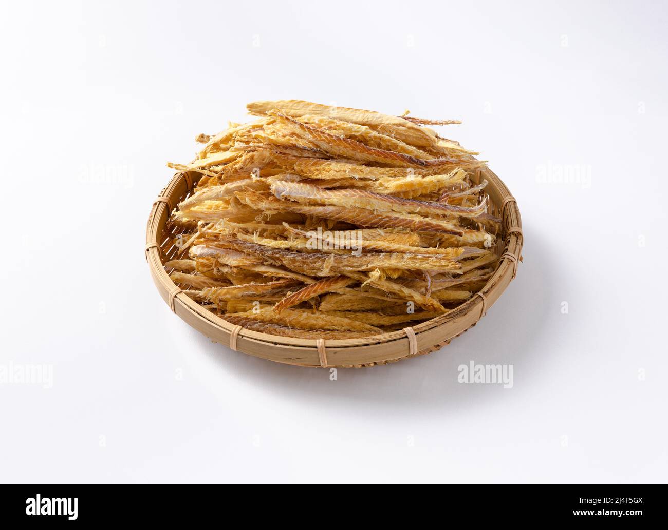Thinly sliced dried pollack in a traditional basket Stock Photo