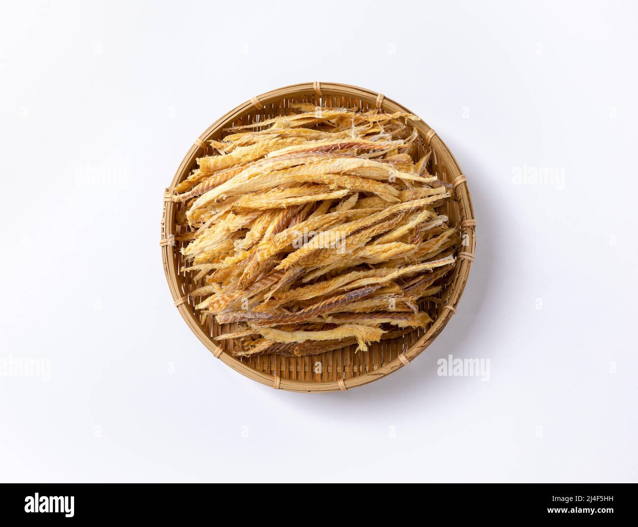 Thinly sliced dried pollack in a traditional basket viewed from above Stock Photo