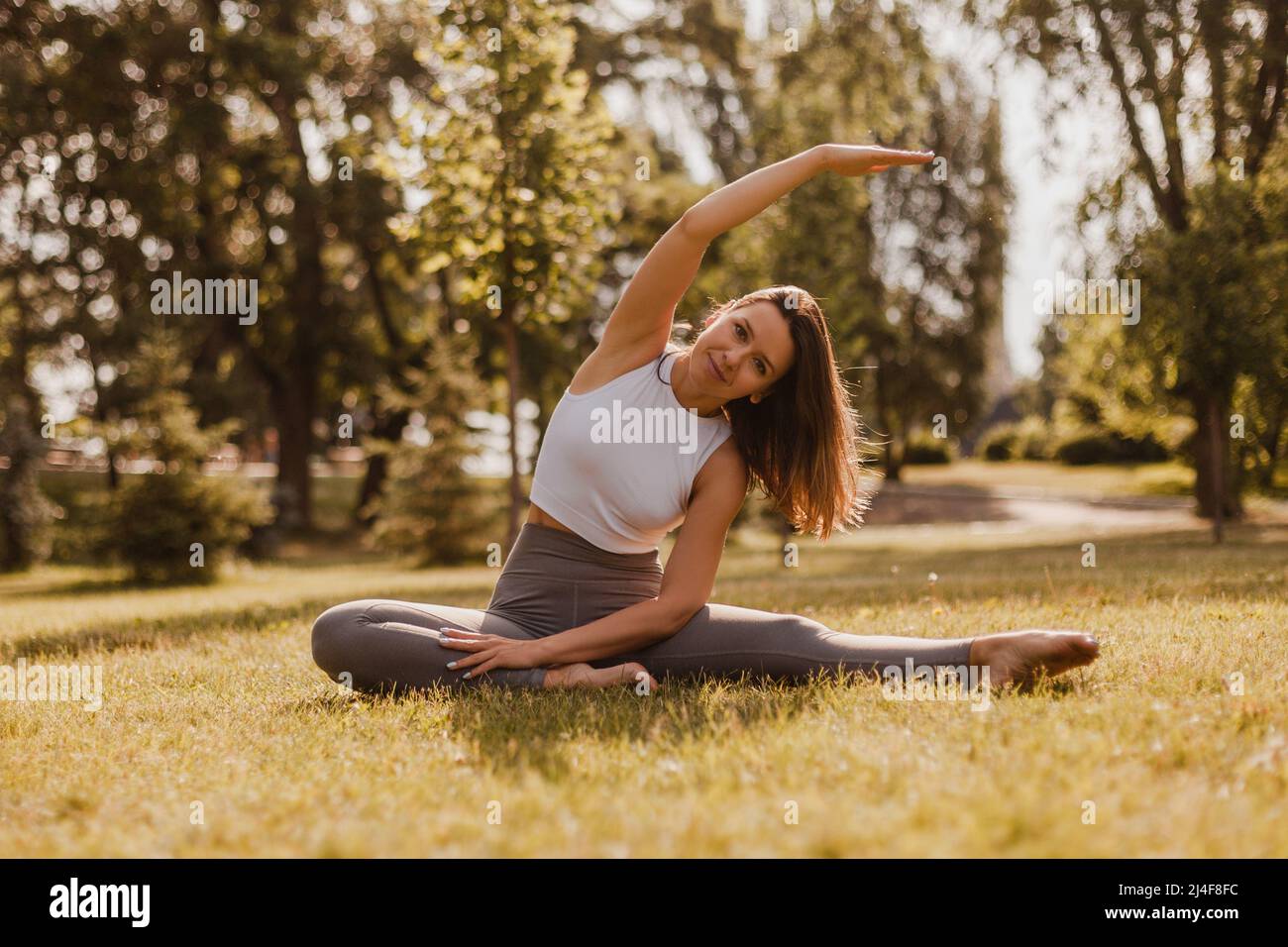 full length yoga concept. sporty slim woman sit in yoga stretching
