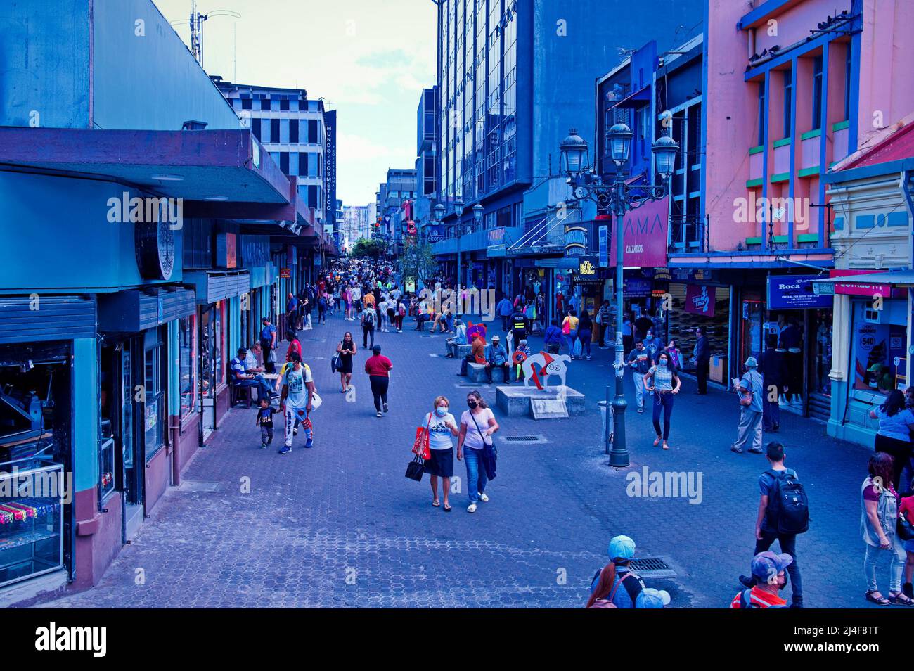 Crowd of anonymous men and women walking down the street Stock Photo