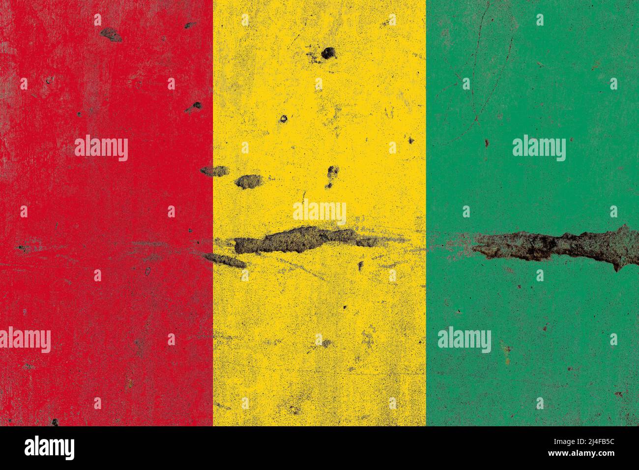 Guinea flag on a damaged old concrete wall surface Stock Photo - Alamy