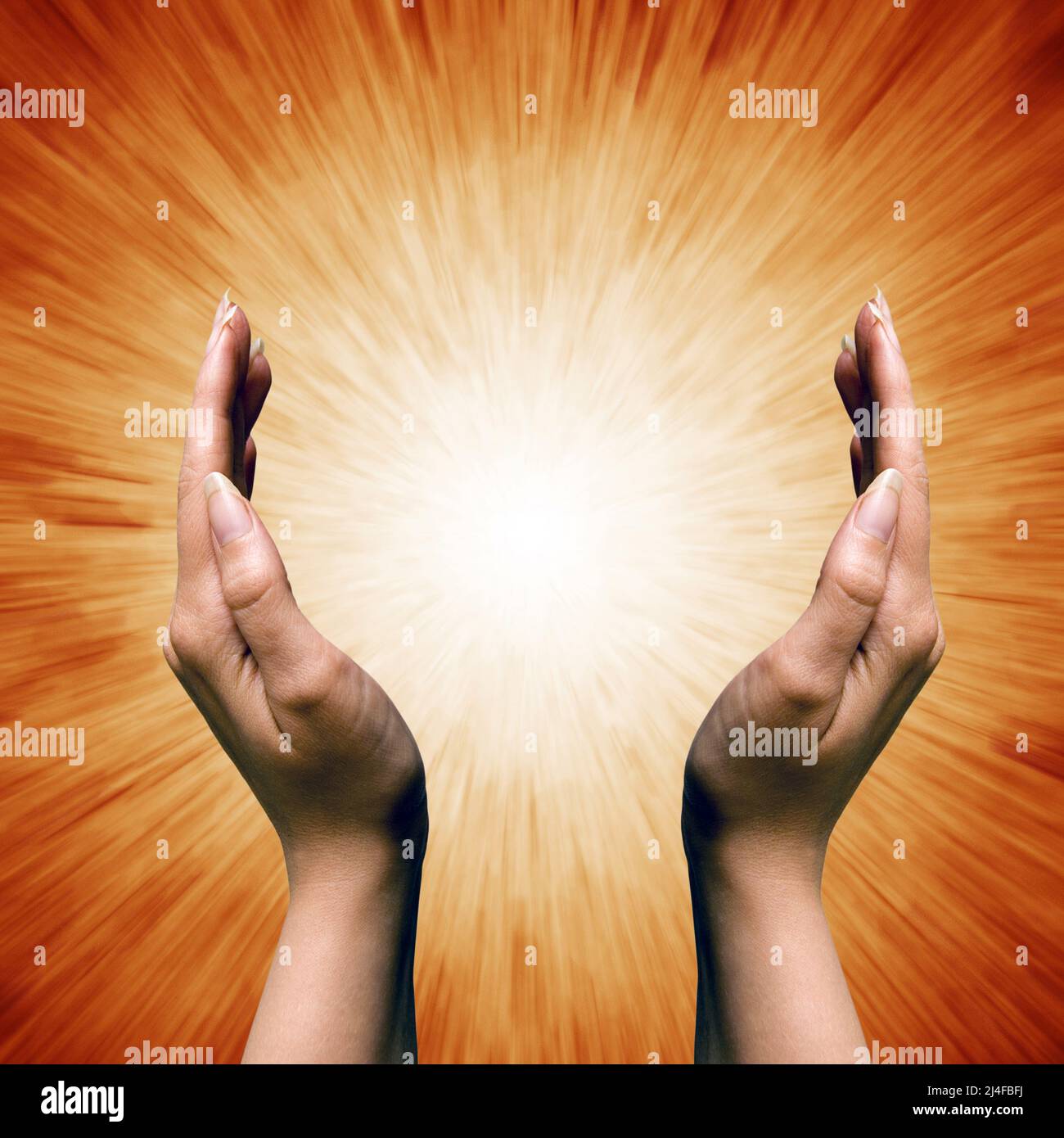 woman hands around a spiritual divine light Stock Photo Alamy