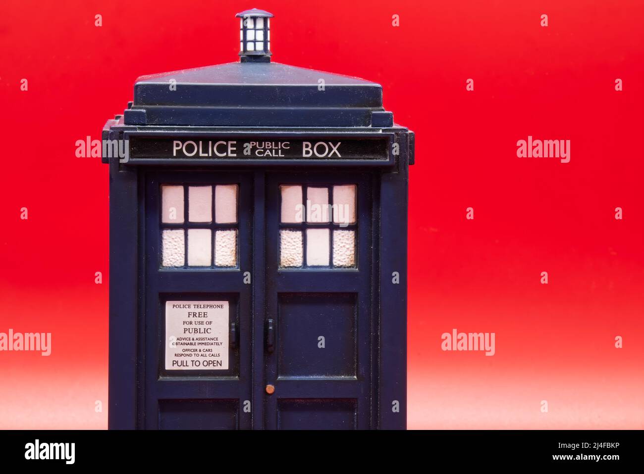 Police call box isolated on red background. Tardis from Doctor Who. Stock Photo