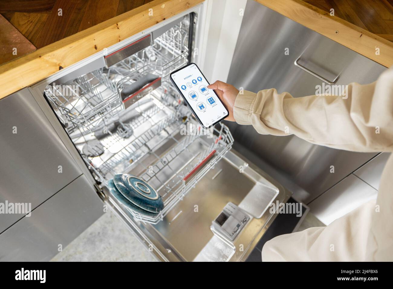Controlling dishwasher with smart phone application Stock Photo Alamy