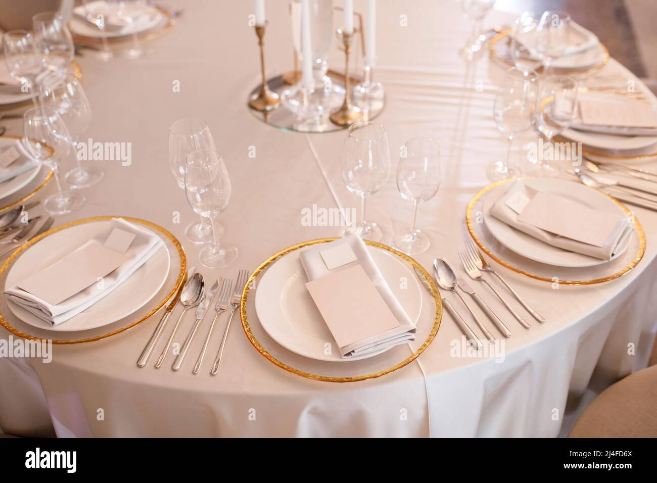 Tables setting at a luxury wedding. Table for guests. Dishes and drinks