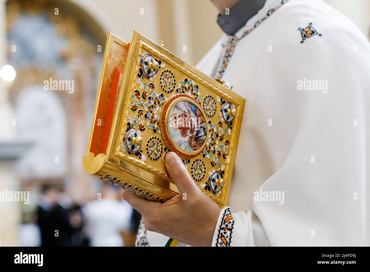 Closeup of catholic priest&rsquo;s hands holding the Holy Bible, Ukraine