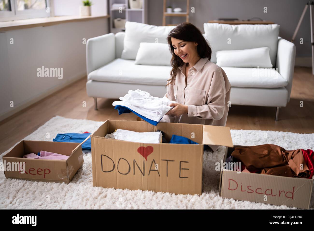 Donating Decluttering And Cleaning Up Wardrobe Clothes Stock Photo